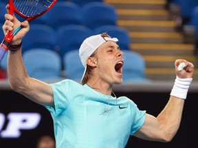 Canada's Denis Shapovalov celebrates beating Italy's Jannik Sinner during their men's singles match on Day 1 of the Australian Open in Melbourne on Monday, Feb. 8, 2021.