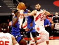 Raptors' Fred VanVleet (right) passes the ball to teammate DeAndre' Bembry as Orlando Magic's Dwayne Bacon defends during the first quarter at Amalie Arena in Tampa on Sunday, Jan. 31, 2021.