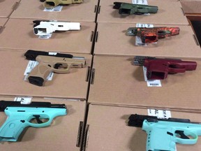 In this file photo taken on June 22, 2018, seized firearms are seen on display during a Toronto Police Service press conference to update the public on the results of raids, which took place across the Greater Toronto Area.