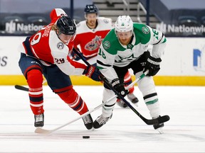 Patrick Laine #29 of the Columbus Blue Jackets and Joe Pavelski #16 of the Dallas Stars battle for control of the puck during the first period at Nationwide Arena on Tuesday night. Laine was help pointless in the Stars 6-3 win.