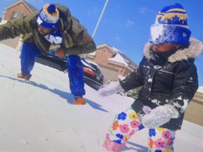 Willie Jefferson and daughter Kelley spend time outside their house near Austin, Tex., where a number of relatives are staying to have access to water and power.