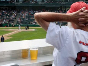 A patron enjoys a beverage in the Craft Beer Corner while watching the Winnipeg Goldeyes battle the Milwaukee Milkmen during American Association baseball action at Shaw Park on June 23, 2019.