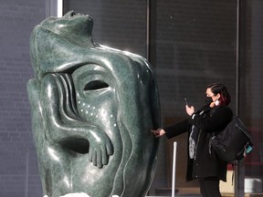 A person photographs a Goota Ashoona outdoor sculpture at WAG-Qaumajuq, in Winnipeg. Winnipeg was chosen for Winnipeg Art Gallery’s Qaumajuq, which holds the world’s largest public collection of contemporary Inuit art, as well as the city’s other dynamic and inspiring attractions.