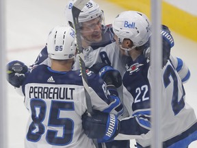 The Winnipeg Jets celebrate a second period goal against the Edmonton Oilers by forward Mason Appleton (22) at Rogers Place in Edmonton on Monday.