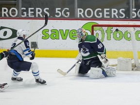 Winnipeg Jets forward Pierre-Luc Dubois (13) scores the overtime game winning goal on Vancouver Canucks goalie Braden Holtby (49) at Rogers Arena. Jets won 4-3 in Overtime.  Bob Frid-USA TODAY Sports