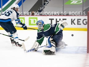 Mark Scheifele of the Winnipeg Jets scores on goalie Thatcher Demko of the Vancouver Canucks for 1-0 lead in the first period at Rogers Arena  on Friday, Feb. 19, 2021 in Vancouver.