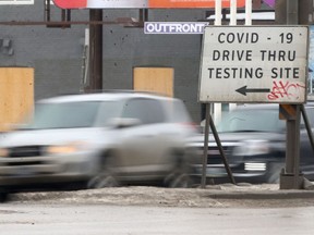 Vehicles pass a sign for a Covid-19 testing site, in Winnipeg. Wednesday, February 03, 2/2021.Winnipeg Sun/Chris Procaylo/stf