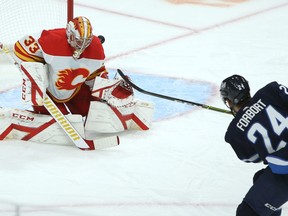 Winnipeg Jets defenceman Derek Forbort beats Calgary Flames goaltender David Rittich for his first goal with the team, in Winnipeg on Tues., Feb. 2, 2021. Kevin King/Winnipeg Sun/Postmedia Network