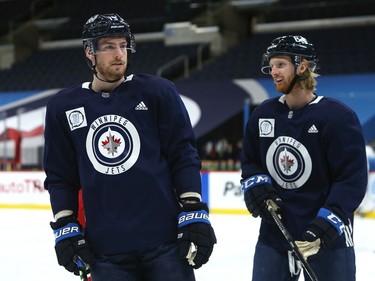 Pierre-Luc Dubois (left) chats with Kyle Connor during his first practice with the Winnipeg Jets on Sunday, Feb. 7, 2021.