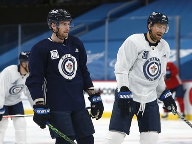 Pierre-Luc Dubois (left) chats with captain Blake Wheeler during his first Winnipeg Jets practice on Sunday, Feb. 7, 2021.
