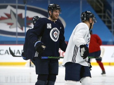 Pierre-Luc Dubois (left) chats with Paul Stastny during his first Winnipeg Jets practice on Sunday, Feb. 7, 2021.