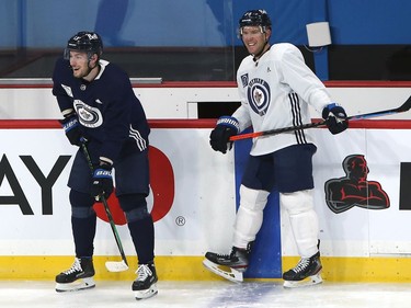 Pierre-Luc Dubois (left) shares a laugh with Paul Stastny during his first Winnipeg Jets practice on Sunday, Feb. 7, 2021.