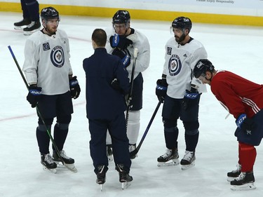 Pierre-Luc Dubois (left) listens to Winnipeg Jets assistant coach Jamie Kompon along with Andrew Cop, Mathieu Perreault and Neal Pionk (from left) during practice on Sunday, Feb. 7, 2021.
