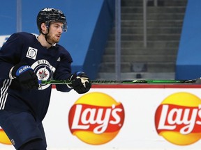 Pierre-Luc Dubois follows through on a shot during Winnipeg Jets practice on Sunday, Feb. 7, 2021.