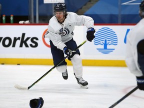Mark Scheifele skakes during Winnipeg Jets practice in Winnipeg on Monday.