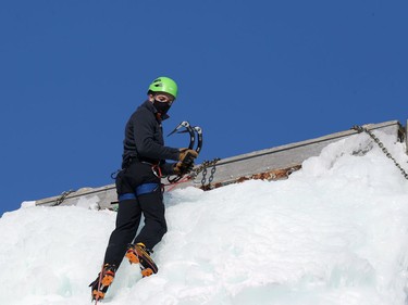 A masked ice climber looks down from the top of the structure at the Club d'escalade Saint-Boniface in Winnipeg in Winnipeg on Sun., Feb. 21, 2021. Kevin King/Winnipeg Sun/Postmedia Network