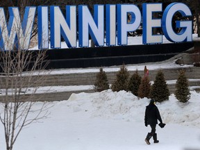 A person walks past a Winnipeg sign, at The Forks, in Winnipeg. Tuesday, February 23, 2/2021.Winnipeg Sun/Chris Procaylo/stf