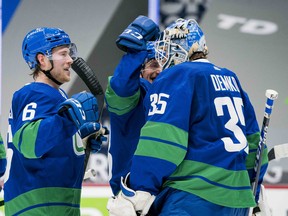 Vancouver Canucks forward Brock Boeser (6) celebrates the Canucks victory with goalie Thatcher Demko (35) against the Toronto Maple Leafs earlier this month.