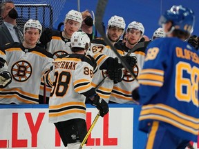 David Pastrnak (88) of the Bruins celebrates his goal against the Sabres during the third period at KeyBank Center in Buffalo, N.Y., on March 18, 2021.
