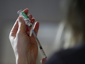 Dr. Joss Reimer, medical lead, Manitoba Vaccine Implementation Task Force draws a dose of the AstraZeneca COVID-19 vaccine at a clinic in Winnipeg, Friday, March 19, 2021. John Woods/POOL/The Canadian Press