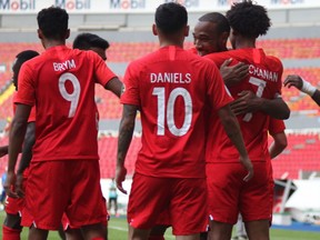 Canadian forward Tajon Buchanan (7) is congratulated by his teammates including Adian Daniels (10) and Charles Brym (9) after scoring against El Salvador at the CONCACAF Men's Olympic Qualifying tournament at the Jalisco Stadium in Guadalajara, Mexico on March. 19, 2021.