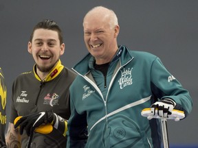 Calgary Ab, March 7, 2021.WinSport Arena at Canada Olympic Park.Tim Hortons Brier.Team Wild Card 3, skip Glenn Howard jokes with team Wild Card 1, lead Colin Hodgson during draw 6,Howard substituted to lead position for the end of the game. Curling Canada/ Michael Burns Photo