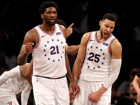 Joel Embiid (21) and Ben Simmons of the Philadelphia 76ers celebrate a win over the Brooklyn Nets at Barclays Center on April 20, 2019.