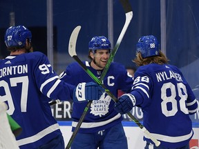 Maple Leafs forward William Nylander (88) celebrates a goal against Winnipeg with forwards John Tavares (91) and Joe Thornton (97) at Scotiabank Arena.