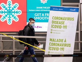 A man walks through terminal 3, amid a spike in COVID-19 cases, at Pearson airport near Toronto, Dec. 30, 2020.