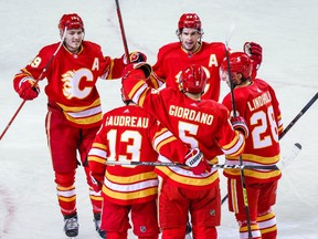 Flames defenceman Mark Giordano (5) celebrates his goal with teammates against the Winnipeg Jets during the first period at Scotiabank Saddledome in Calgary on Saturday, March 27, 2021.