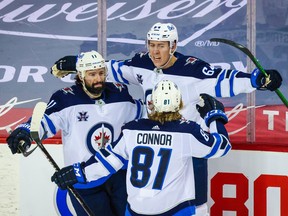 Winnipeg Jets defenceman Logan Stanley (64) celebrates his goal against the Calgary Flames during the second period at Scotiabank Saddledome in Calgary on Saturday, March 27, 2021.