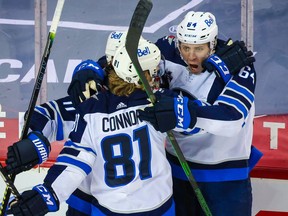 Winnipeg Jets defenceman Logan Stanley (64) celebrates his goal against the Calgary Flames during the second period at Scotiabank Saddledome in Calgqary on Saturday, March 27, 2021.