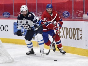 Montreal Canadiens forward Joel Armia (40) plays the puck against Winnipeg Jets defenceman Josh Morrissey (44) during the second period at the Bell Centre in Montreal on Saturday, March 6, 2021.