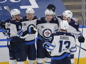 Winnipeg Jets forward Nikolaj Ehlers (27) is greeted by team mates after scoring against Toronto Maple Leafs in the third period at Scotiabank Arena in Toronto.