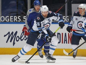 Blake Wheeler #26 of the Winnipeg Jets passes the puck against the Toronto Maple Leafs during their game at Scotiabank Arena on March 9, 2021 in Toronto, Ontario, Canada.