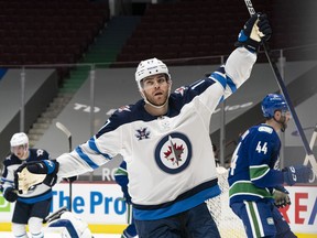Adam Lowry (17) of the Winnipeg Jets celebrates after scoring a goal against the Vancouver Canucks during the third period of NHL action at Rogers Arena on March 22, 2021 in Vancouver.