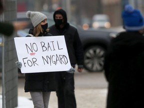 A group of people assembled near the law courts in Winnipeg to oppose a bail application made by lawyers representing Peter Nygard on Wednesday, Feb. 3, 2021.