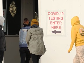 People enter the COVID testing site at Assiniboia Downs in Winnipeg on Wed., March 3, 2021. Kevin King/Winnipeg Sun/Postmedia Network