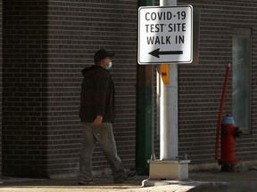 A man walks near a COVID-19 testing site in downtown Winnipeg on Monday, March 8, 2021.