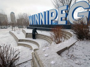 An employee sets up candles for a COVID-19 memorial in front of the Winnipeg sign at The Forks on Thurs., March 11, 2021. A total of 643 candles Ñ one for each person in the Winnipeg health region lost to the pandemic in the year since the first case emerged Ñ will be on display until March 14. Kevin King/Winnipeg Sun/Postmedia Network