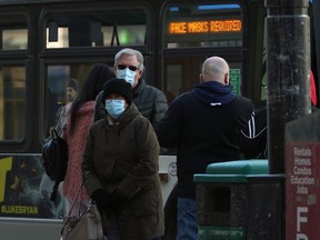 People with masks getting on and off a Winnipeg Transit bus downtown on Sunday, March 14, 2021.