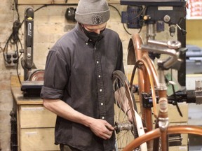 Sam Stevens of Natural Cycleworks attends to bike maintenance in the co-op’s shop in Winnipeg’s Exchange District on Tuesday, March 23. 2021.