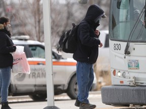 Passengers wait to board at Winnipeg Transit bus on Tuesday. There are a growing number of assaults on buses, prompting the union representing Transit workers to call for better protection.
