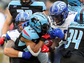 Austin Walter (27) of the Dallas Renegades is tackled by Casey Sayles (90) and Gimel President (53) of the St. Louis Battlehawks in the first half of an XFL football game on Feb. 9, 2020 in Arlington, Texas.