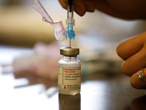 Nurse Brenda Lotakoun draws a dose of the Moderna COVID-19 vaccine as nurses from Humber River Hospital staff administer vaccines to residents, staff, and volunteers at one of B'nai Brith Canada's affordable housing buildings in Toronto, March 23, 2021.