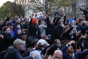 Chelsea fans celebrate outside the stadium before the match after reports suggest they are set to pull out of the European Super League.