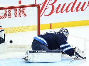 Winnipeg Jets goaltender Connor Hellebuyck is beaten on a shot by Edmonton Oilers defenceman Darnell Nurse during Monday's game.