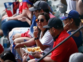 Baseball fans in Arlington, Texas, watch Monday's game between the Blue Jays and the Rangers without wearing masks.