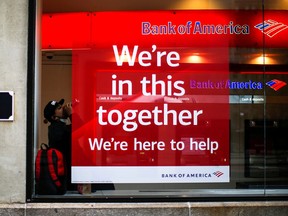 A man takes shelter from the rain inside of a Bank of America branch in the financial district, during the outbreak of the coronavirus disease (COVID-19) in New York City April 23, 2020.