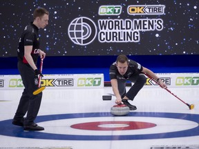 Team Canada skip Brendan Bottcher delivers his stone as Marc Kennedy readies to brush during their final practice before opening against Scotland in the world championship on Friday.